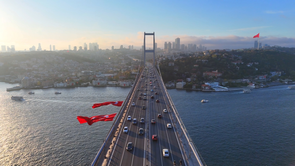 Ez az isztambuli Július 15. vértanúinak hídja (korábban Boszporusz híd) napfelkeltekor vagy napnyugtakor, török zászlókkal díszítve. 